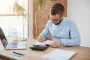 young-caucasian-male-manager-glasses-sitting-company-office